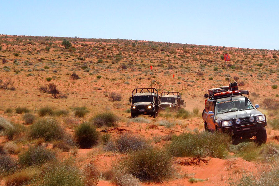 Three 4WD vehicles driving in the outback of Australia. 