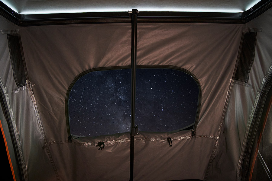 Looking up at the night sky through the skylight of a Darche Ridgeback Hard Shell roof top tent.