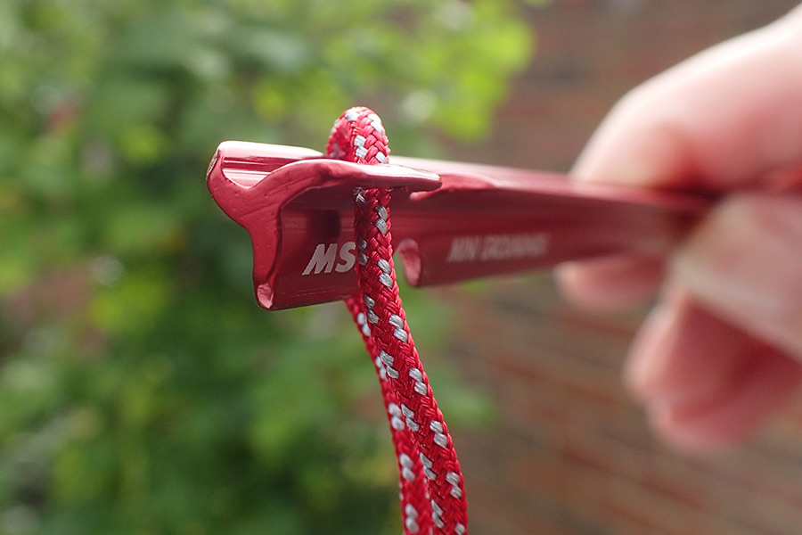 A red MSR Groundhog Tent Stake with pull-loop attached.