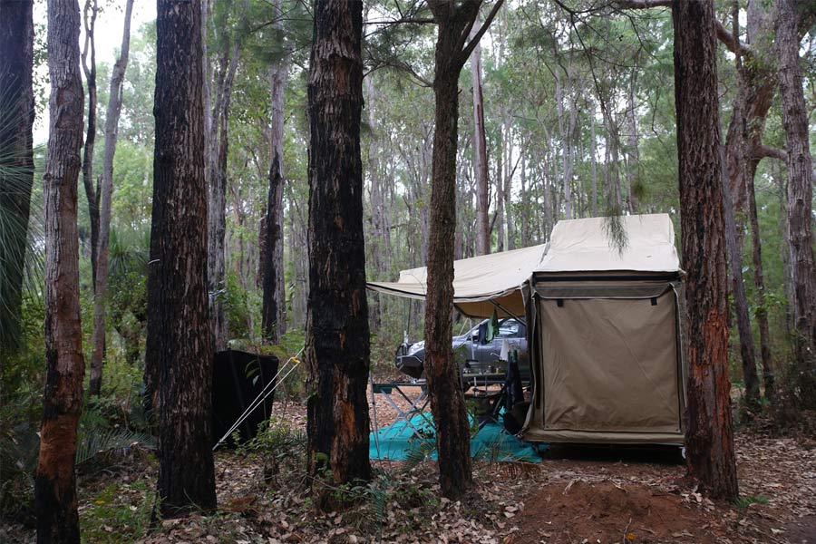 A camp set up in the middle of a forest. 