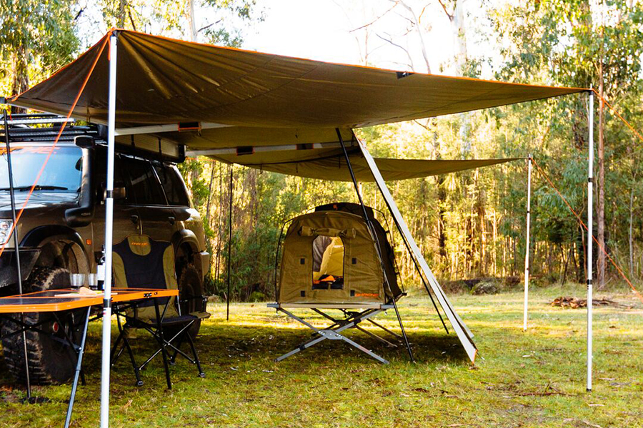Ben and Lauren tackle a collection of listener queries about the practical side of campsite living A campsite setup with a 4WD, swag, stretcher, camp table, and awning.